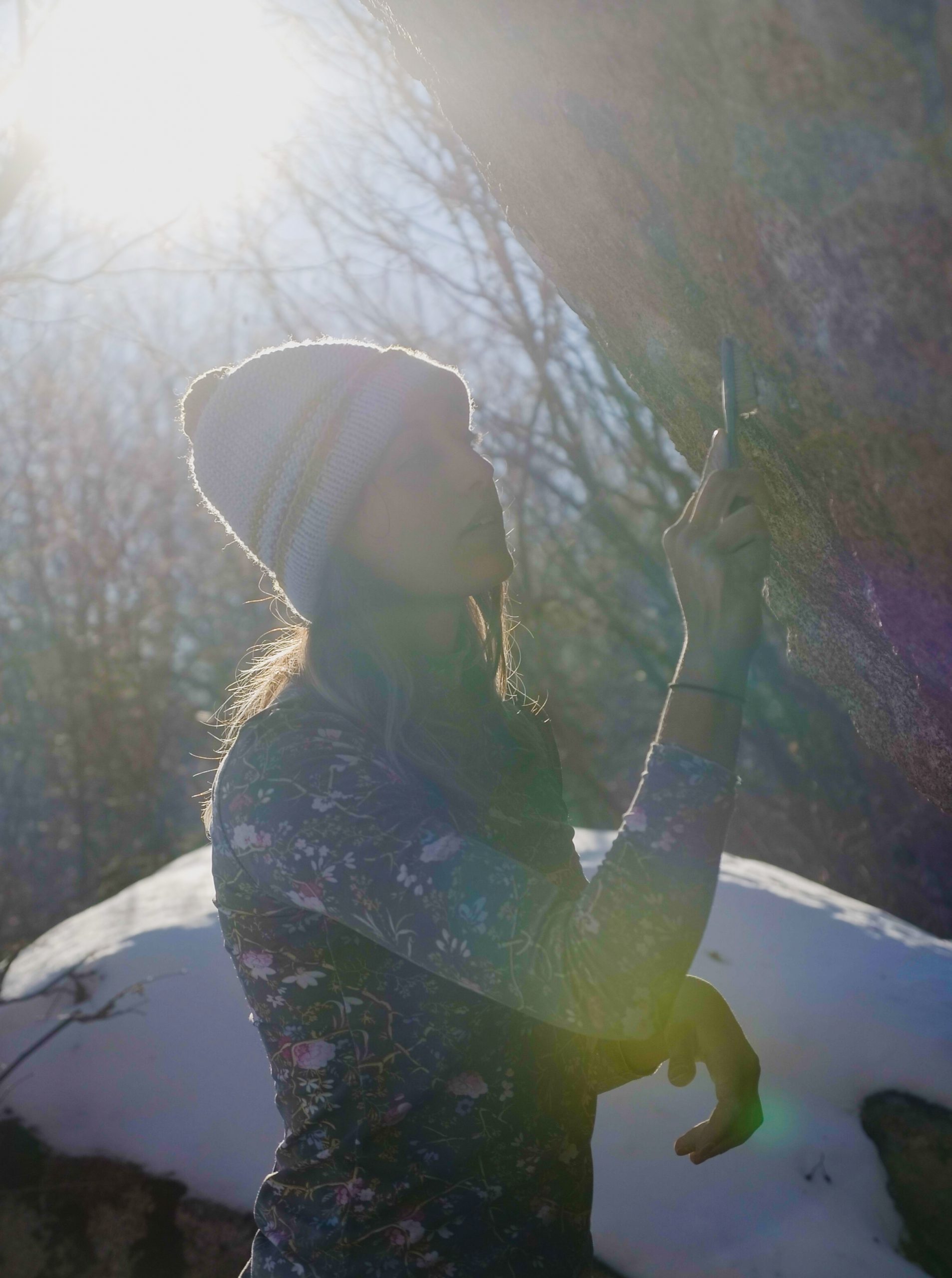 Anna Hazelnutt brushing a hold on a boulder